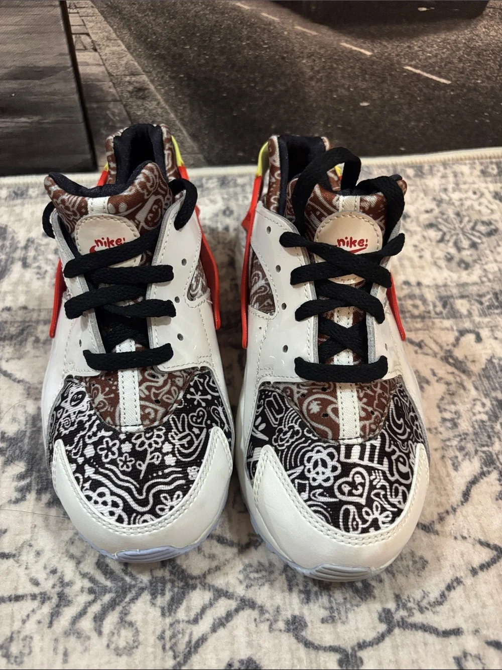 Nike Huarache Kids White Sneakers with Black Pattern, Orange & Yellow Accents